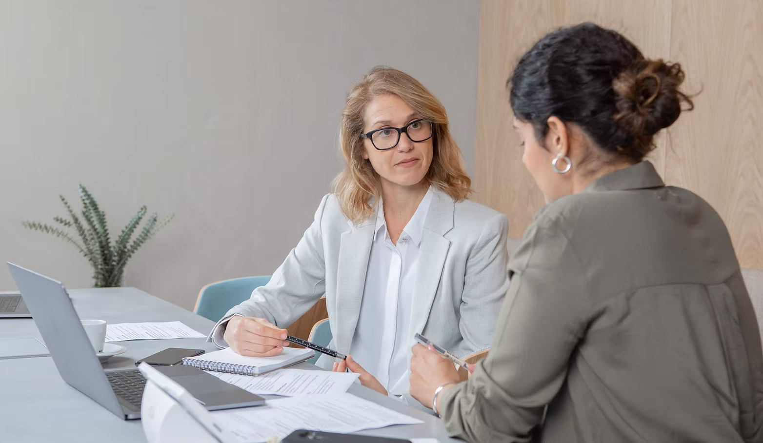 Two women reviewing documents together in an office